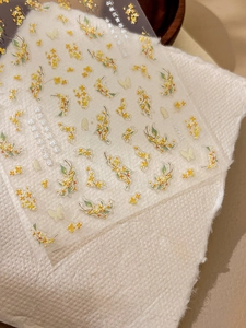 Macro shot of 3D embossed osmanthus and butterfly nail stickers with Chinese poems