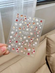 Detail of autumn maple leaf nail art stickers with red ginkgo patterns for manicure decoration