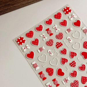 3D embossed nail art stickers with red and white hearts, bows, and candy designs