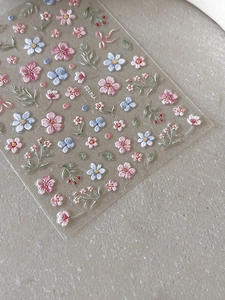 Detail of 3D embossed floral nail stickers featuring pink flowers and ribbons YT4103