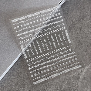 Self-adhesive white lace nail art stickers with embossed floral and bow designs