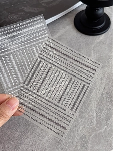 Detailed view of YT4286 black and white lace 3D embossed nail art stickers on a dark background