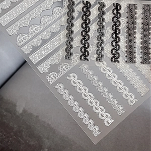 Elegant black and white lace nail art stickers with embossed 3D floral stripe patterns