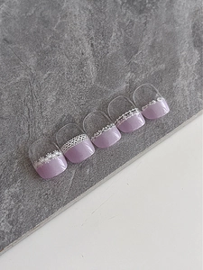 Detail of taro purple toe press-on nails with white lace flowers and 3D embossed texture