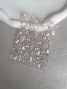 Macro shot of 3D embossed nail stickers featuring pink rabbits, flowers, and bows YT4102