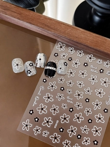 Detailed view of YT4155 black and white hollow flower nail stickers with 3D embossed texture