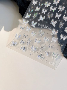 Macro shot of colorful laser butterfly nail stickers with starlight holographic finish