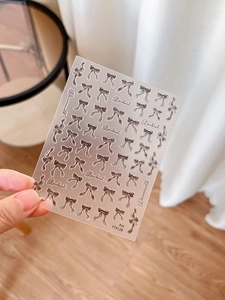 Detail of brown ribbon bowknot nail art stickers with Dreamwood typography model YT4128