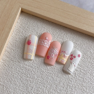 3D embossed press-on nails with rabbit, bow, and floral designs in peach pink and white