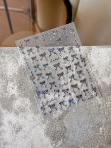 Holographic bowknot nail art stickers with laser finish and dreamy artistic lettering