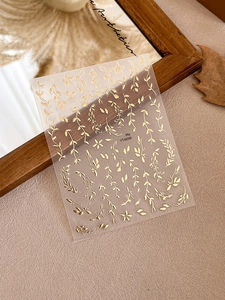 Macro detail of gold metallic leaf and vine nail art stickers with YT4098 marking