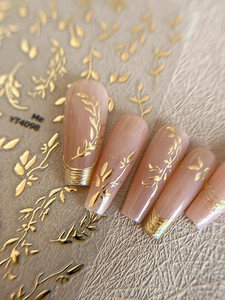 Detail of gold leaf and vine nail stickers YT4098 on long nude false fingernails