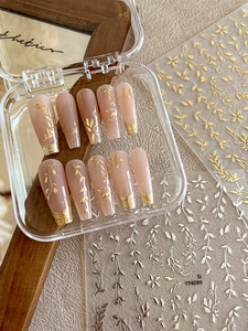 Detailed set of 10 long ballerina press-on nails with gold leaf and floral nail stickers