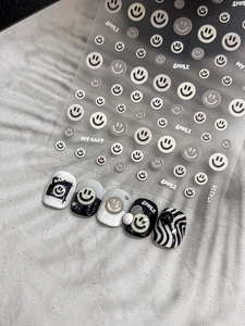 Detailed view of YT4338 embossed smile nail stickers in black, white, and grey tones