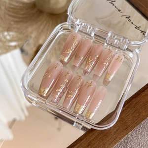 Exquisite gold leaf floral press-on nails in elegant nude pink with shiny finish