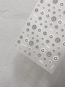 Macro detail of embossed smiley face nail art stickers with SMILE text YT4338