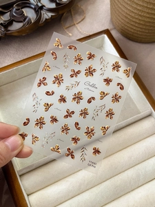 Macro detail of YT4161 autumn flower nail stickers with metallic embossed floral design