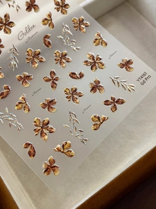 Macro detail of YT4161 golden autumn flower nail stickers with metallic embossed texture