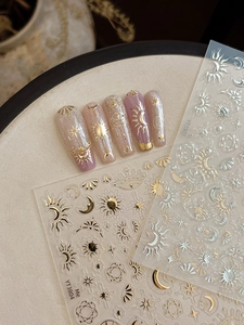 Detail of gold and silver celestial nail art stickers featuring stars and moon designs