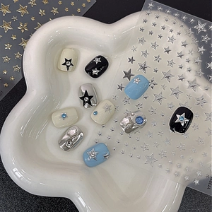 Self-adhesive gold and silver star nail stickers with rhinestones on ceramic tray