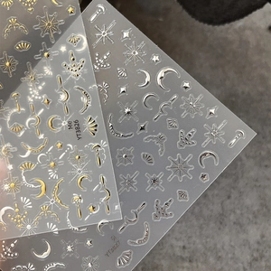 Gold and silver celestial nail stickers with moon and star patterns for 3D manicure art