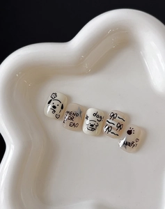 Detail of cute hand-drawn dog and bow motifs on self-adhesive nail art stickers
