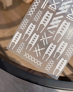 Macro detail of YT4059 nail stickers with white grid lines and gold glitter lace patterns
