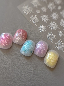 Macro shot of 3D embossed white fireworks nail stickers on colorful gradient nails