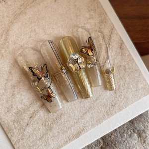 Luxury gold butterfly press-on nails with 3D rhinestones and embossed textures
