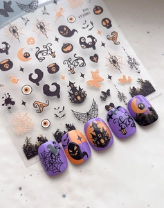 Detailed Halloween nail art stickers with ghosts and castles designs on finished nails