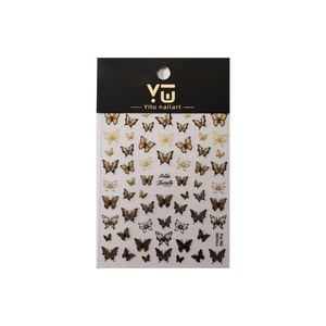 Golden butterfly nail art stickers with relief bronzing on packaging background