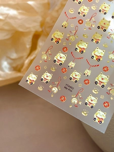 Macro view of 3D embossed gold foil Lucky Cat nail art sticker with YT4492 design