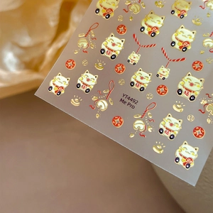 Lucky cat nail stickers in gold and red with embossed lucky charms and fortune cats