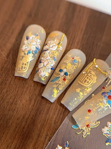 Detail of embossed peony nail stickers with gold foil and Chinese character design