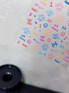 Detail of colorful graffiti nail art stickers with Jinx game characters and icons