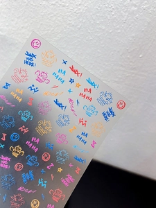 Macro detail of colorful graffiti nail stickers with Jinx punk style text and icons