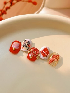 Detail of embossed Fortune Cat nail art with 3D calligraphy and red festive motifs