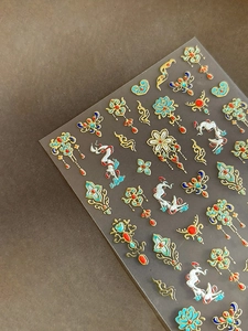 Detailed view of gold bronzing lotus and Nine-Colored Deer nail art stickers