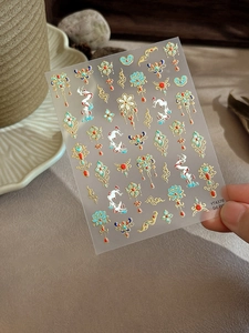 Detail of Chinese gold embossed lotus nail stickers with crane and tassel patterns
