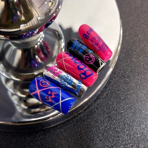 Graffiti style press-on nail kit with colorful scribbles and smiley face designs