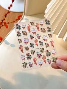 Detail of 3D embossed Fortune Cat nail stickers with traditional Chinese New Year motifs