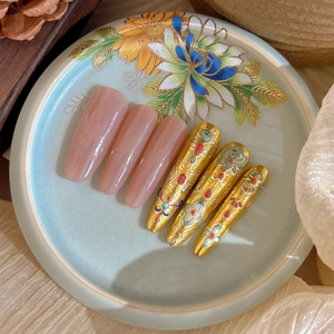 Gold leaf lotus nail art press-on set with traditional Chinese patterns on elegant display