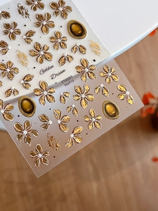 Detail of YT4583 nail stickers featuring golden embossed flowers and white pearls