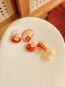 Detailed view of Lucky Cat nail art stickers with red and gold lunar new year motifs