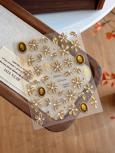 Macro detail of Golden Dream YT4583 embossed nail stickers with gold floral motifs