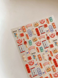 Macro view of 3D embossed Chinese New Year nail stickers with lucky traditional symbols