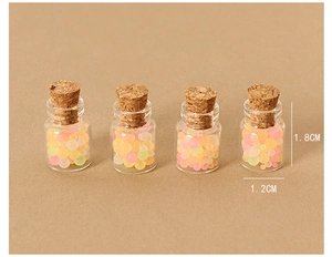 Macro shot of 1.8cm miniature dollhouse glass jars with colorful beads and cork stoppers