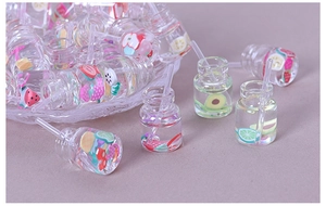 Macro shot of miniature resin fruit juice bottles for DIY crafts and phone case decor