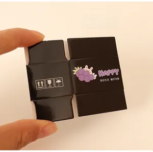 Miniature black dollhouse box with purple bunny and shipping icons on fingers