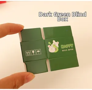 Miniature green box with rabbit avocado print shown in hand for scale